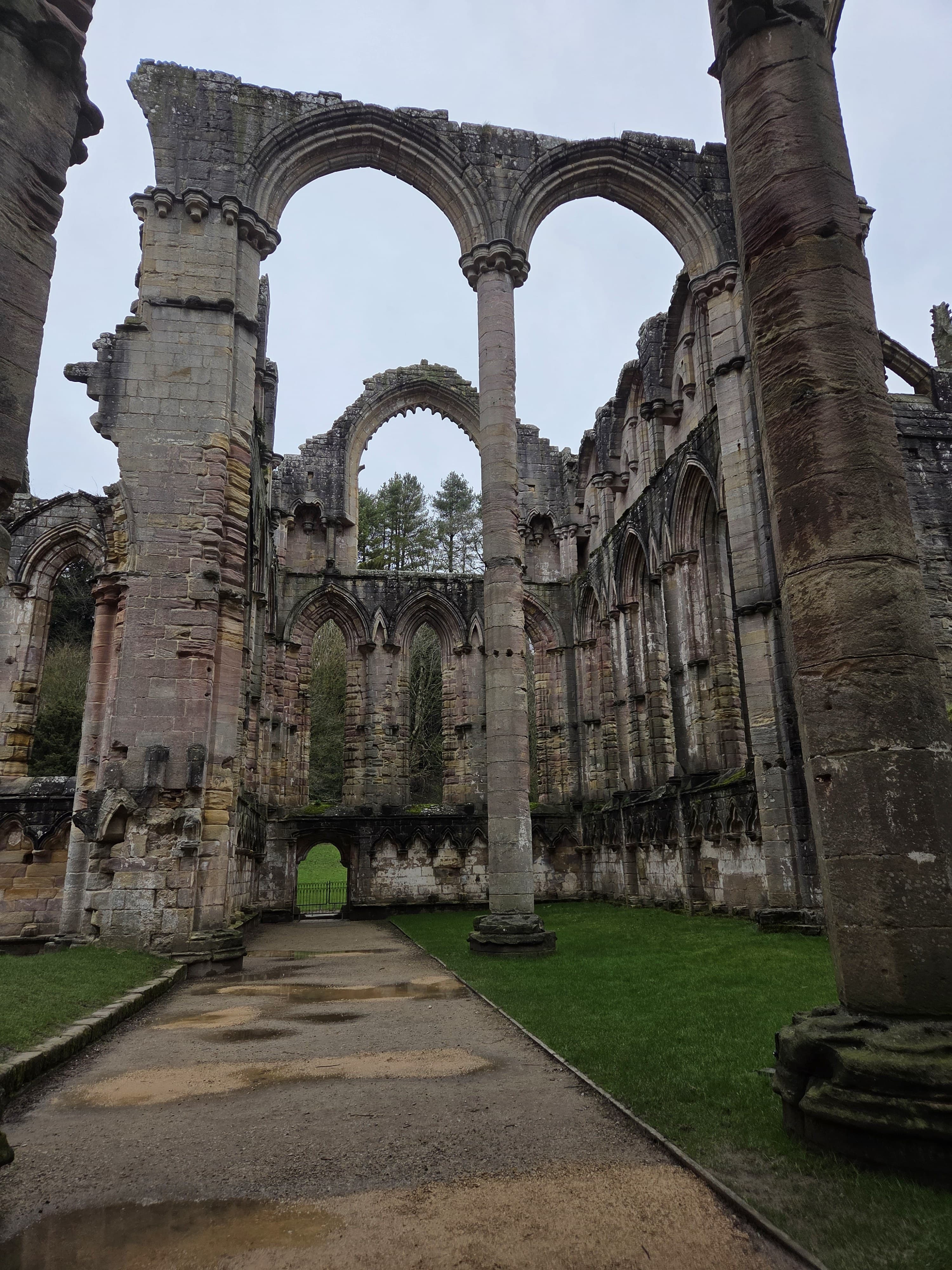 The nave interior with soaring Norman arches and the roof open to the sky
