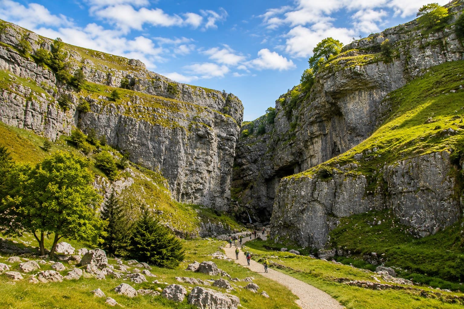The curved limestone cliff face of Malham Cove in the Yorkshire Dales